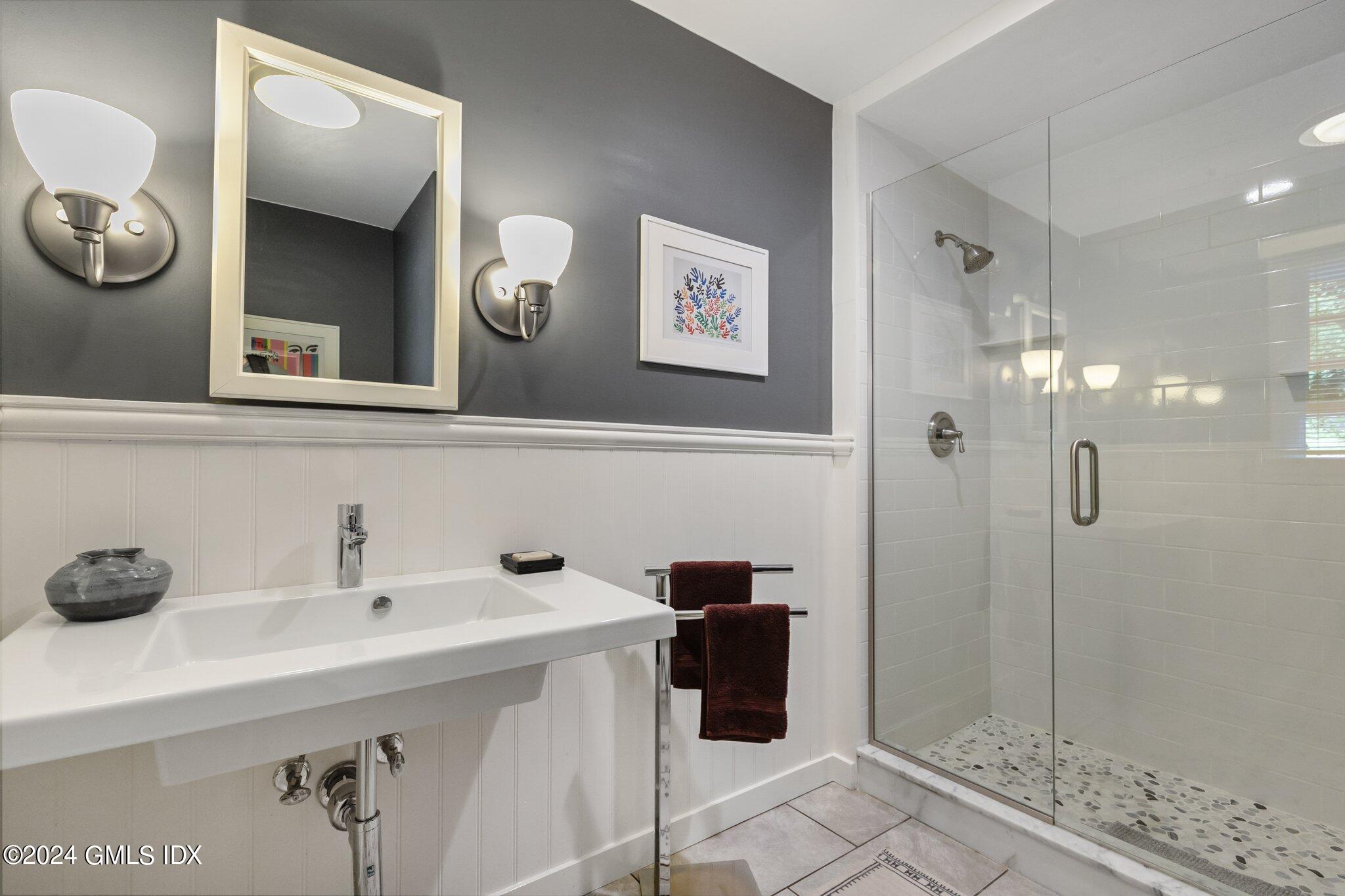300 Orchard Street Greenwich, CT 06830 - Photo 27 of 40 a bathroom with a sink and a mirror