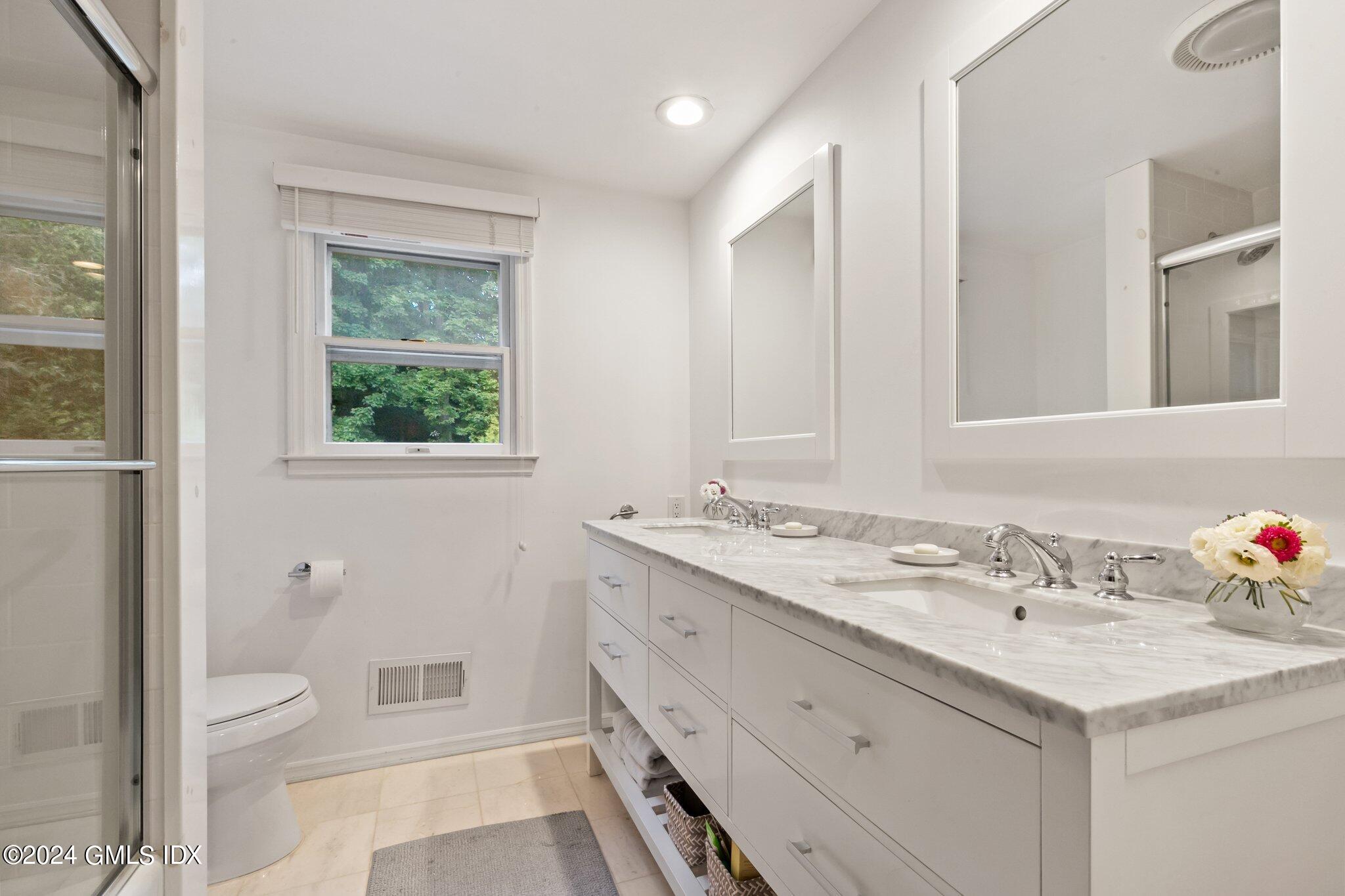 300 Orchard Street Greenwich, CT 06830 - Photo 28 of 40 a bathroom with a sink a toilet and a mirror