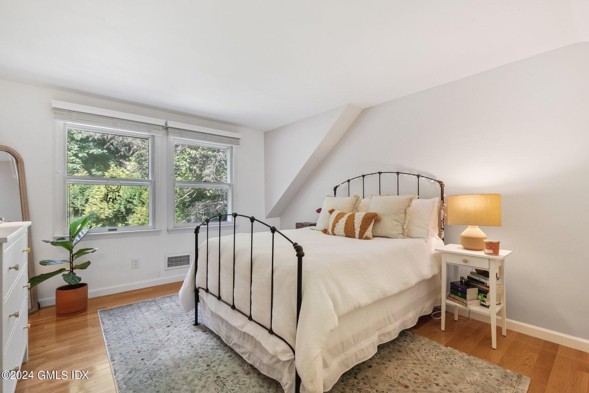 300 Orchard Street Greenwich, CT 06830 - Photo 29 of 40 a bed sitting in a room next to a window