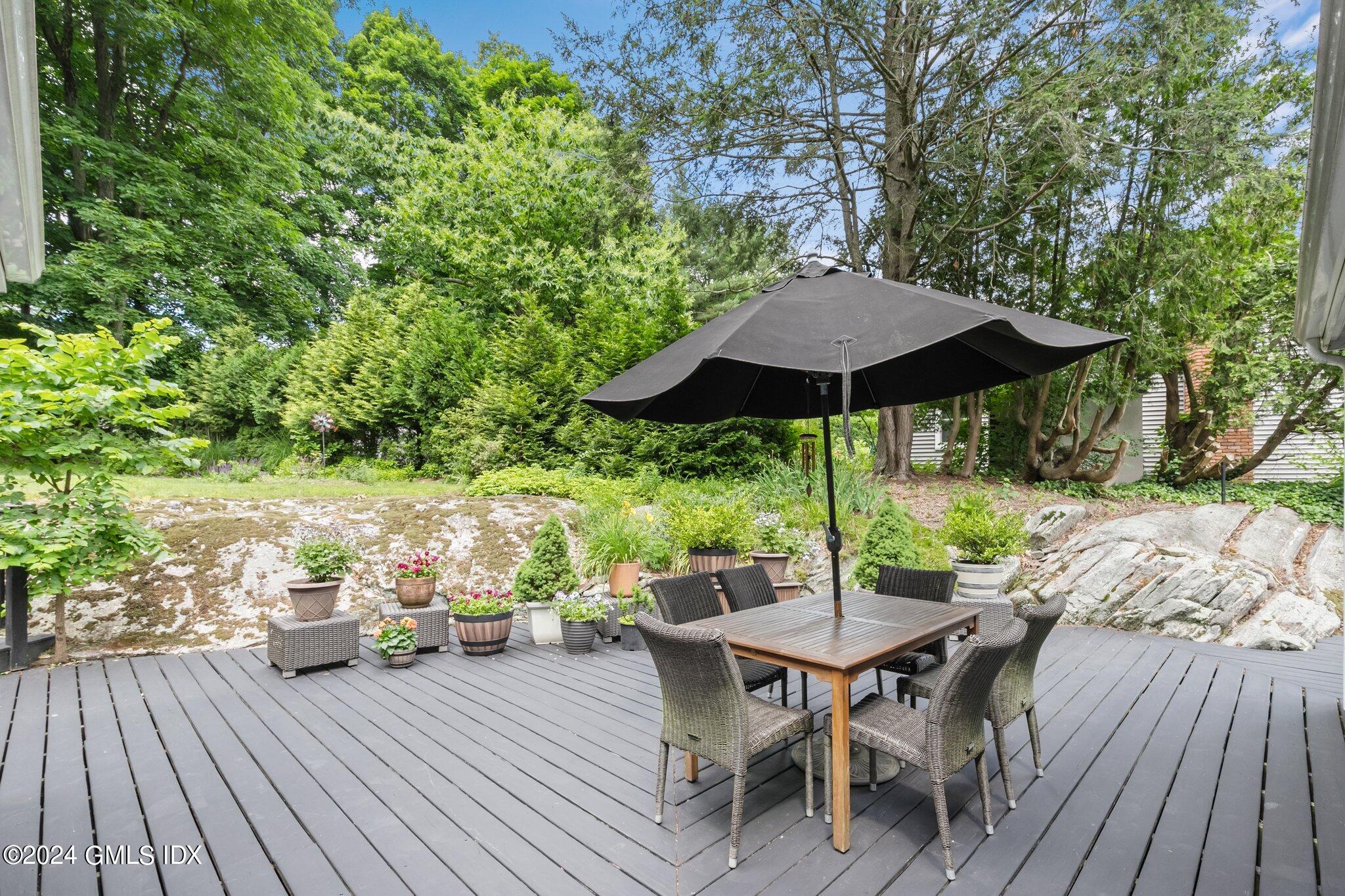 300 Orchard Street Greenwich, CT 06830 - Photo 32 of 40 a view of a table and chairs on wooden deck