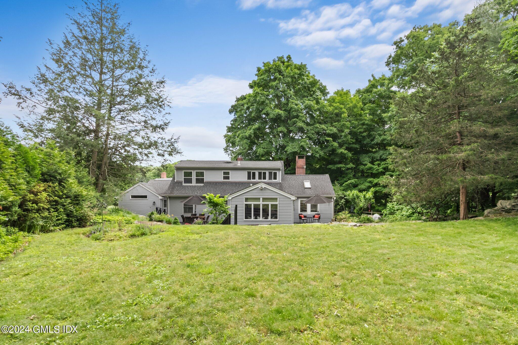 300 Orchard Street Greenwich, CT 06830 - Photo 37 of 40 a view of a house with a yard