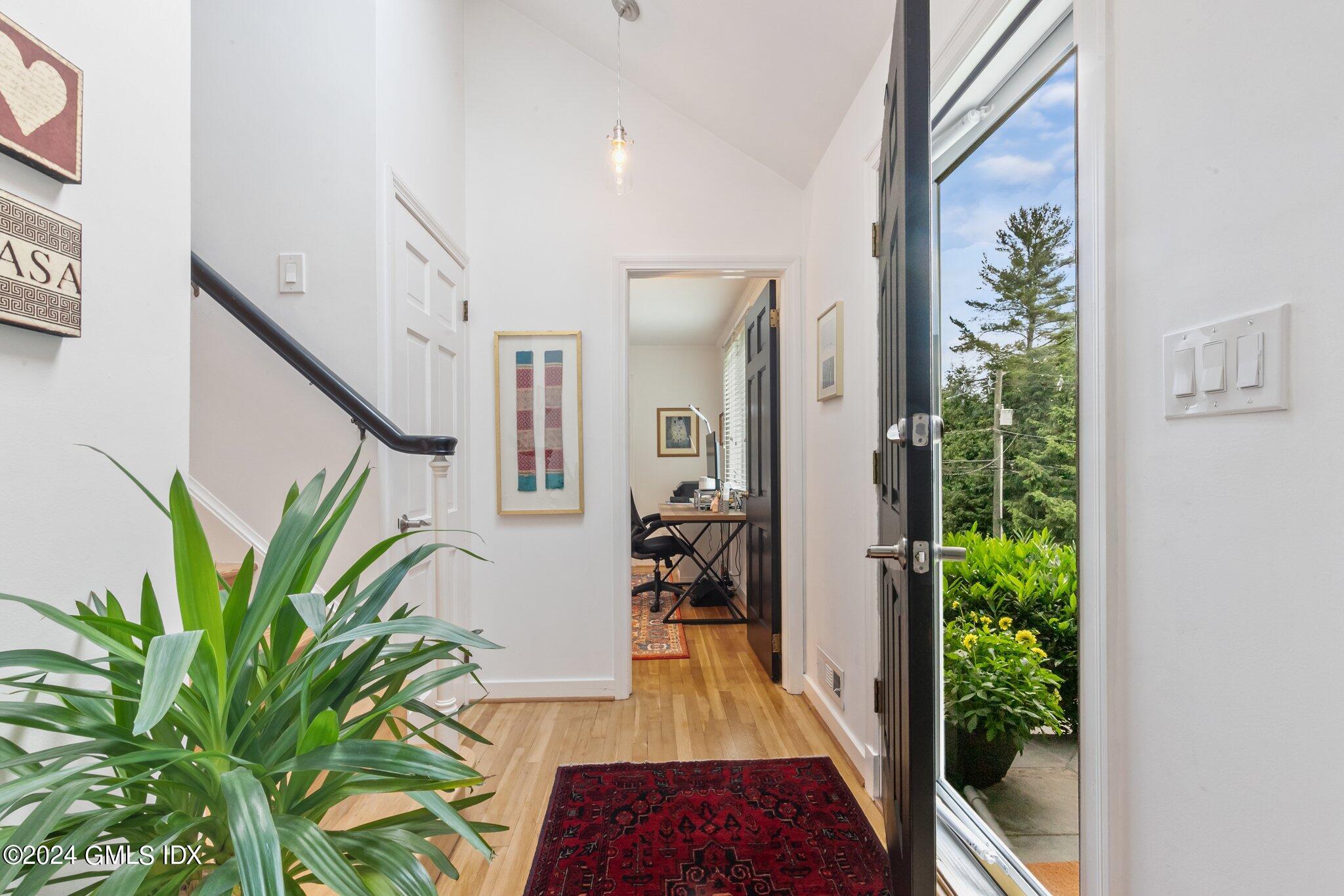 300 Orchard Street Greenwich, CT 06830 - Photo 4 of 40 a hallway with potted plants and floor to ceiling window