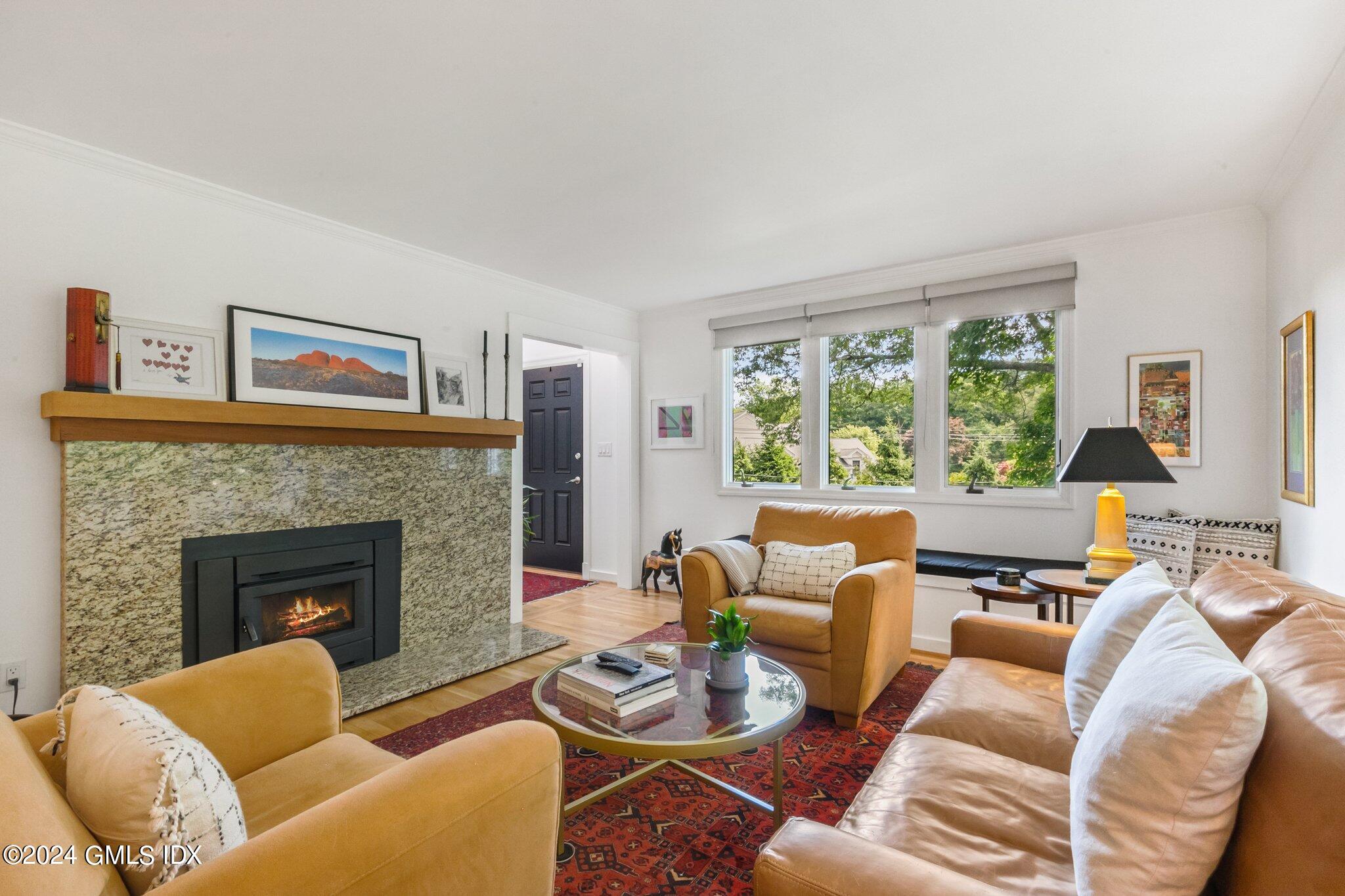 300 Orchard Street Greenwich, CT 06830 - Photo 6 of 40 a living room with furniture and a fireplace