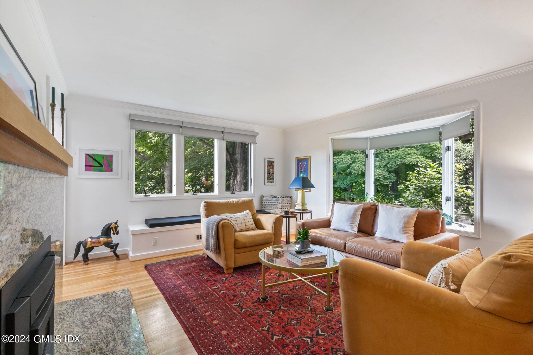 300 Orchard Street Greenwich, CT 06830 - Photo 7 of 40 a living room with furniture and a large window