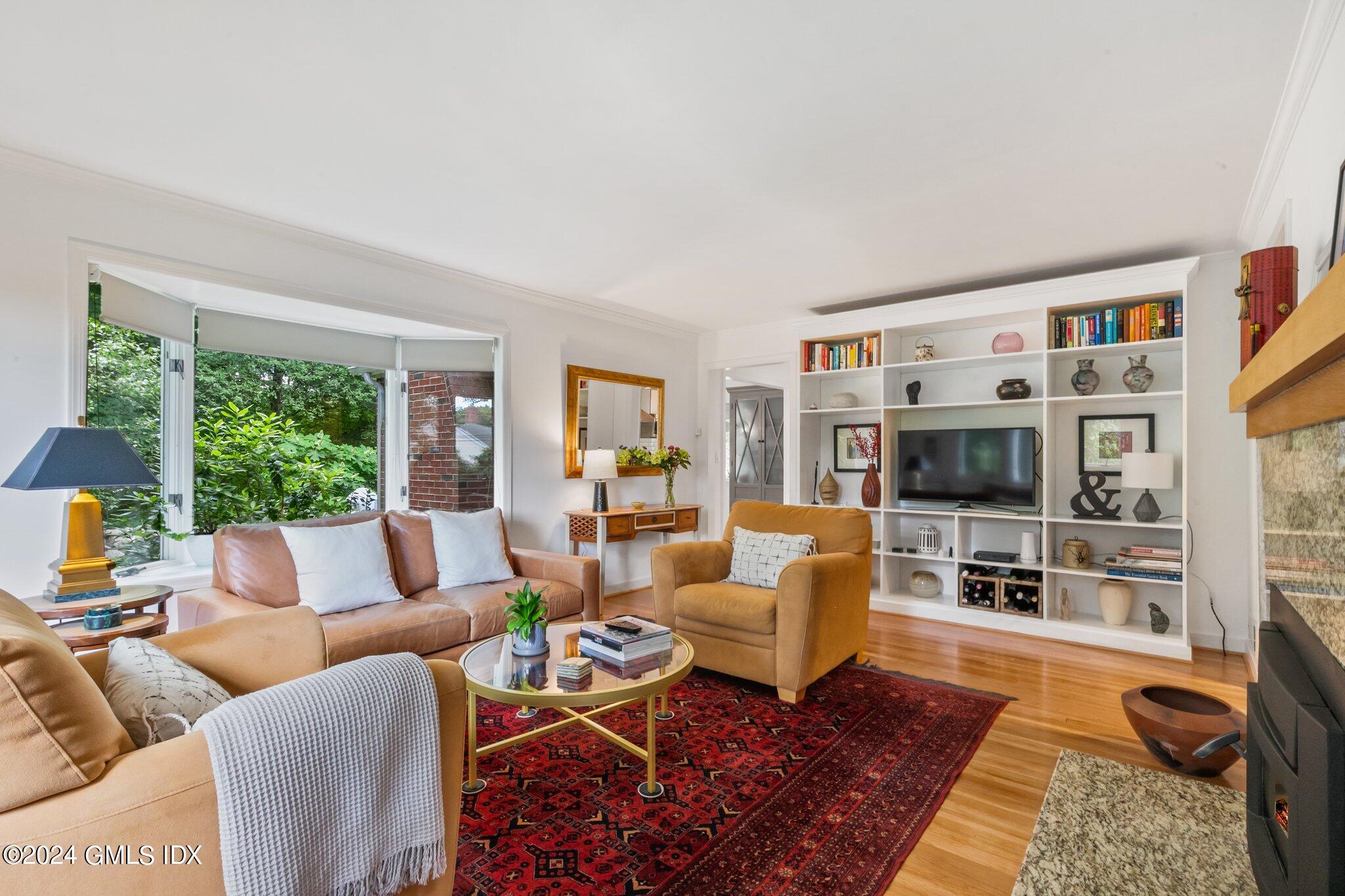 300 Orchard Street Greenwich, CT 06830 - Photo 8 of 40 a living room with furniture flat screen tv and large window