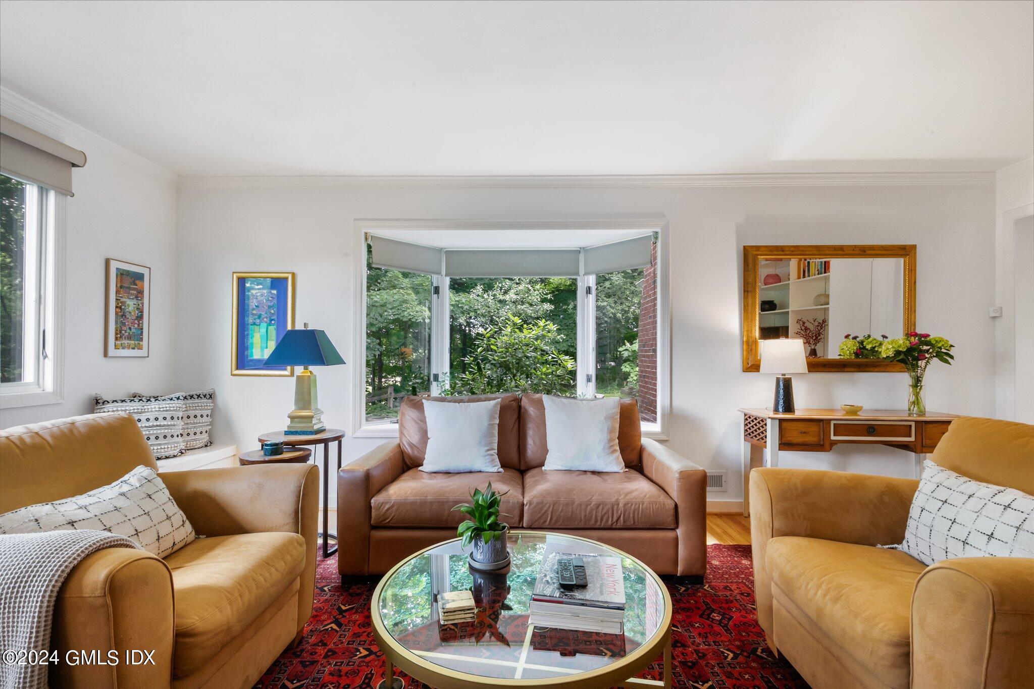 300 Orchard Street Greenwich, CT 06830 - Photo 9 of 40 a living room with furniture and a large window