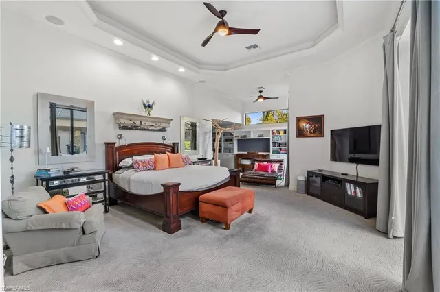 a bedroom with furniture and a flat screen tv