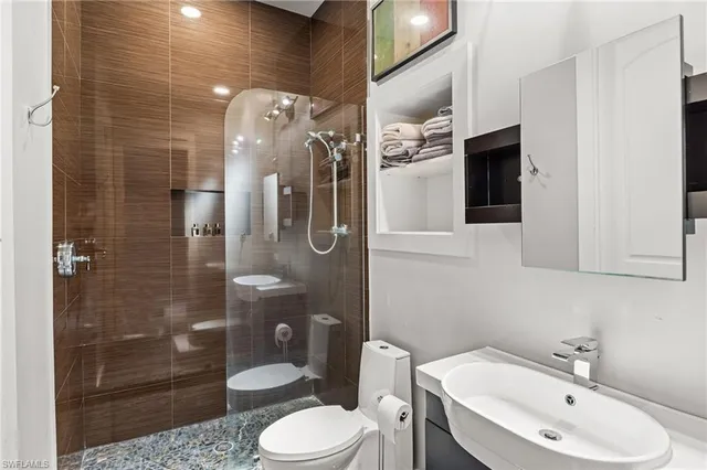 a bathroom with a sink a toilet and shower