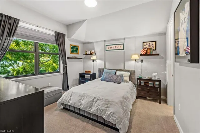 a bedroom with a bed and a large window