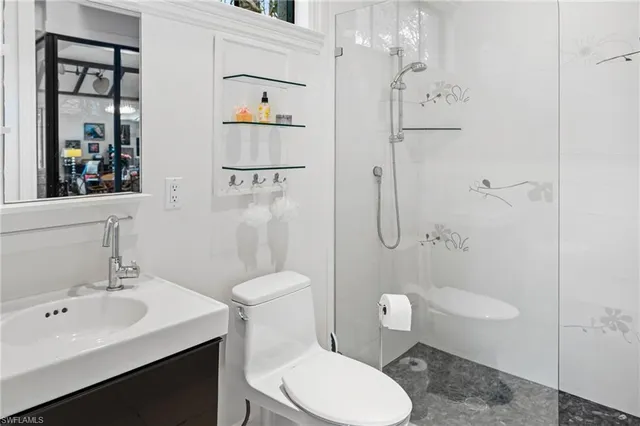 a bathroom with a toilet sink shower and mirror