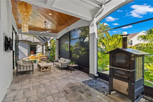 a building outdoor space with patio furniture and potted plants