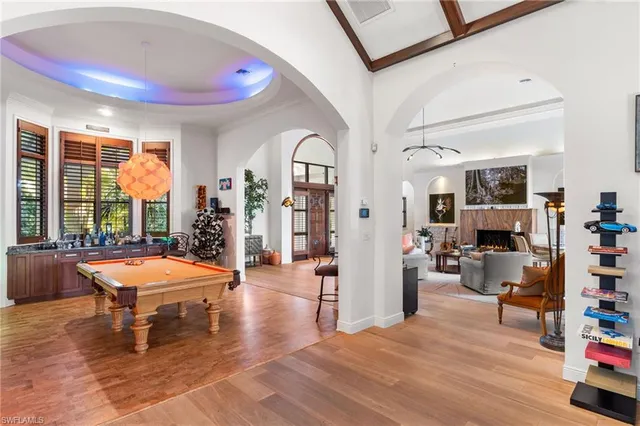 a living room with furniture and large windows