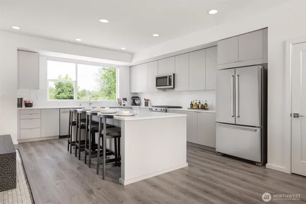 a kitchen with cabinets a sink and appliances