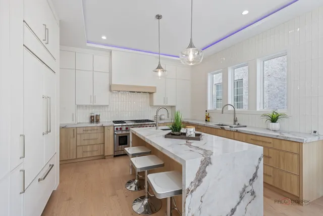 a kitchen with white cabinets and appliances