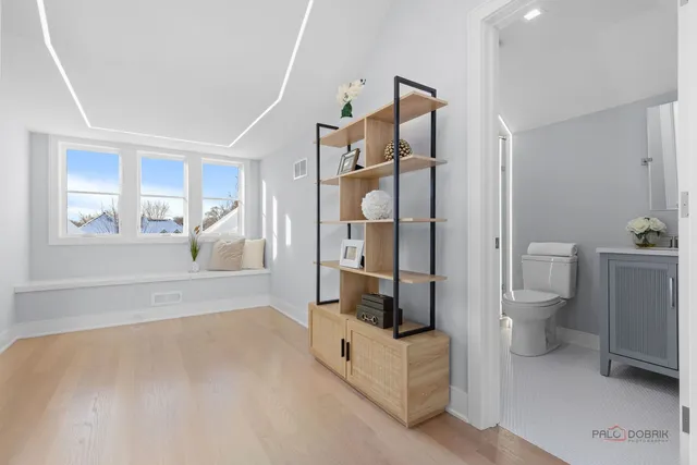 a bathroom with a granite countertop toilet sink and mirror