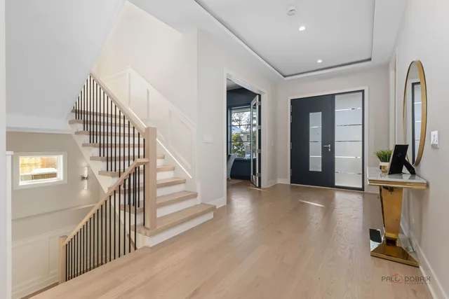 a view of a hallway with wooden floor and windows