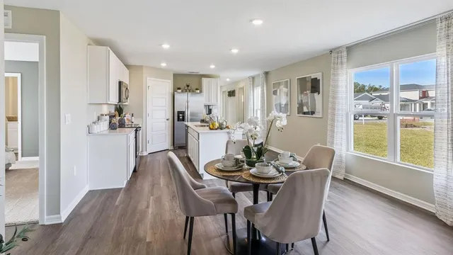a dining room with furniture and window