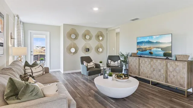 a living room with furniture and wooden floor