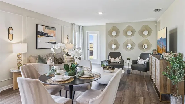 a living room with furniture couches and a large mirror with wooden floor