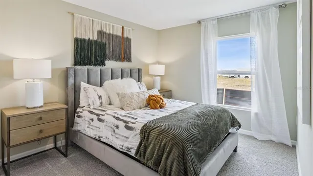 a bedroom with a bed and a mirror