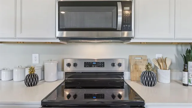 a kitchen with a microwave a stove and cabinets