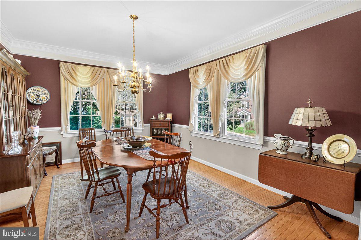 7010 Club House Circle New Market, MD 21774 - Photo 13 of 90 a view of a dining room with furniture large windows and wooden floor