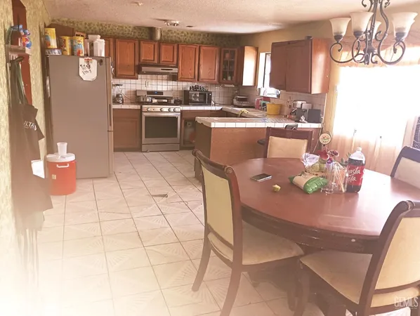 a kitchen with stainless steel appliances kitchen island granite countertop a sink and cabinets