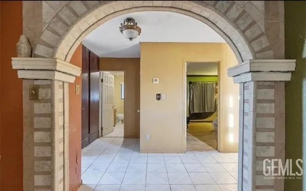 a view of a hallway with wooden shelves