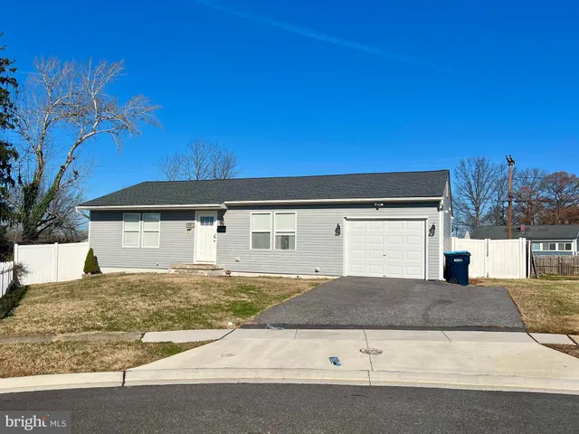 a view of a house with a yard and potted plants