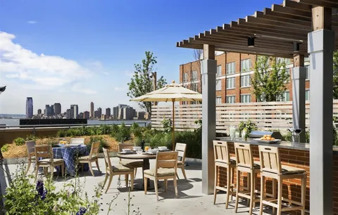 a view of a chairs and table in patio with a lake view