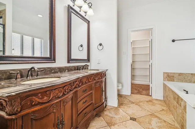 a spacious bathroom with a sink double vanity and a mirror