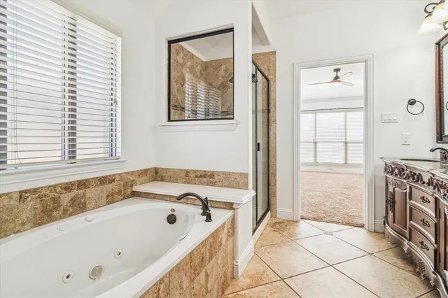 a bathroom with a tub a sink and a window