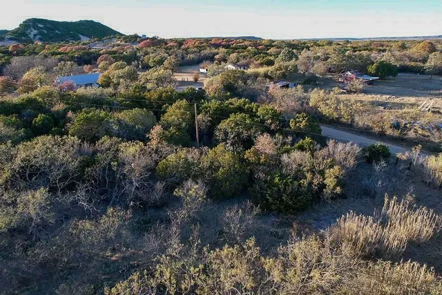 an aerial view of a house with a yard