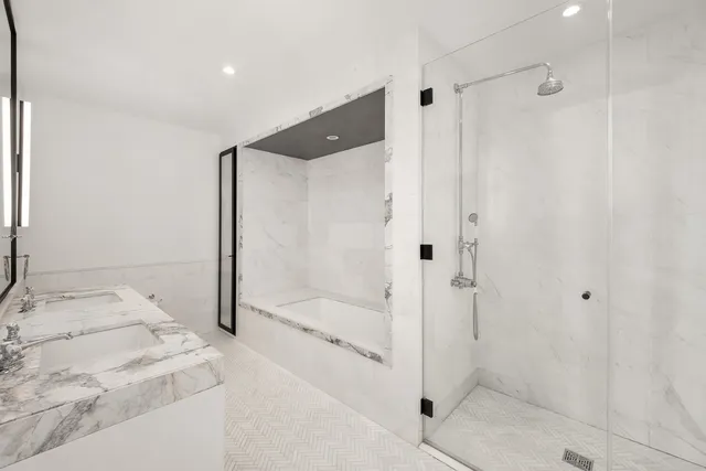 a bathroom with a granite countertop sink mirror and a bathtub