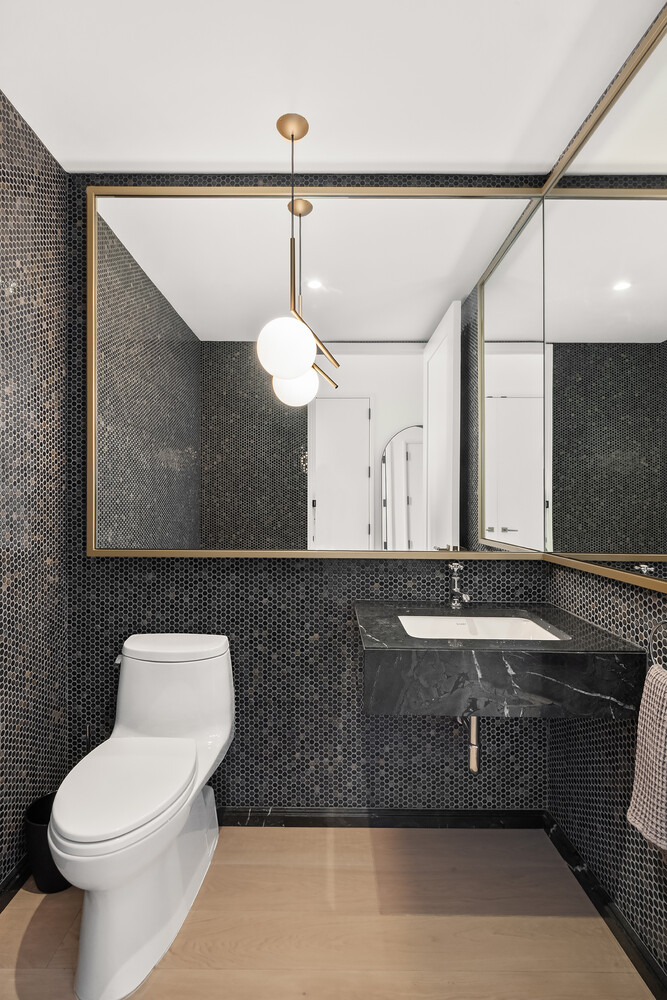 438 East 12th Street, Unit PHF Manhattan, NY 10009 - Photo 12 of 20 a bathroom with a sink a toilet and a mirror