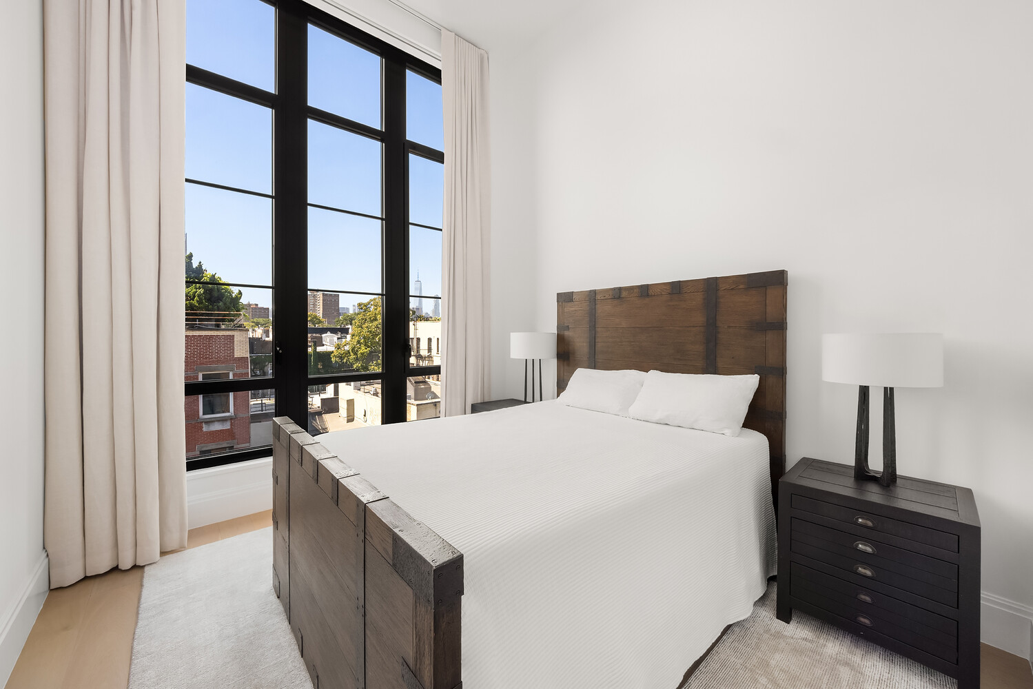 438 East 12th Street, Unit PHF Manhattan, NY 10009 - Photo 13 of 20 a bedroom with a bed and a large window