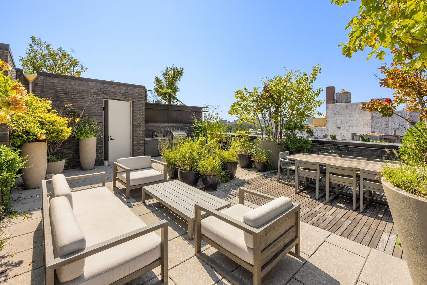 438 East 12th Street, Unit PHF Manhattan, NY 10009 - Photo 16 of 20 a view of a patio with table and chairs and potted plants
