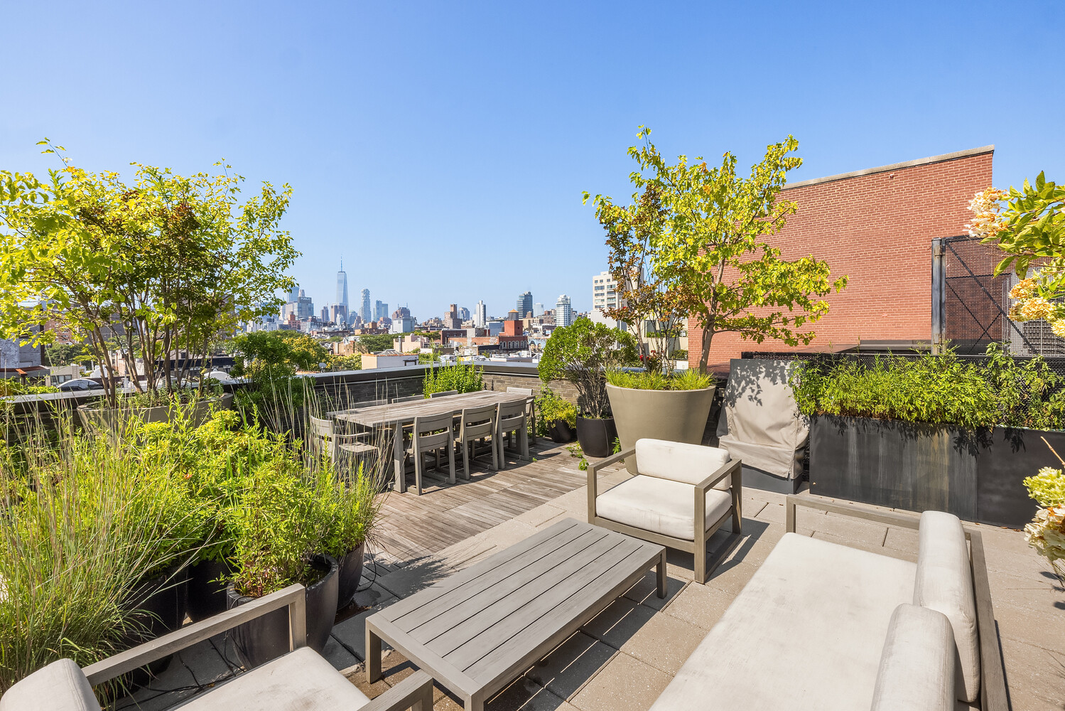 438 East 12th Street, Unit PHF Manhattan, NY 10009 - Photo 17 of 20 a view of a chairs and table in patio with wooden fence