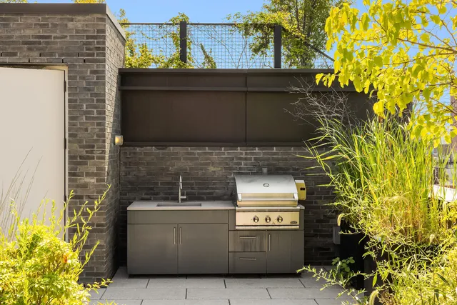 a view of a chairs and table in patio with wooden fence