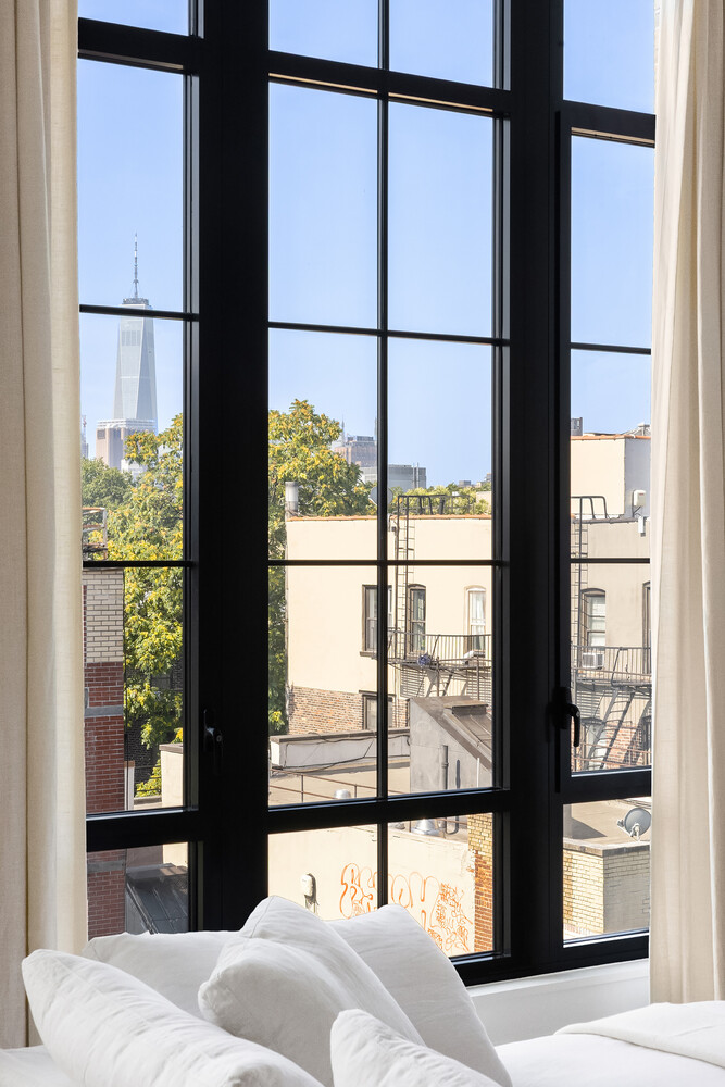 438 East 12th Street, Unit PHF Manhattan, NY 10009 - Photo 19 of 20 a view of a bedroom with furniture and windows
