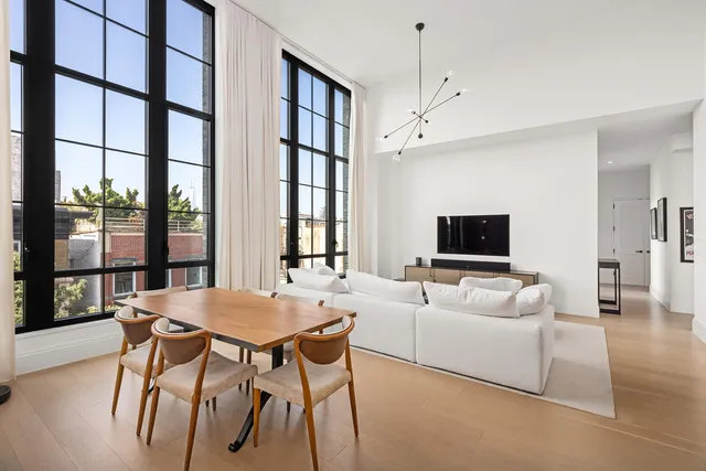 a living room with furniture rug and window