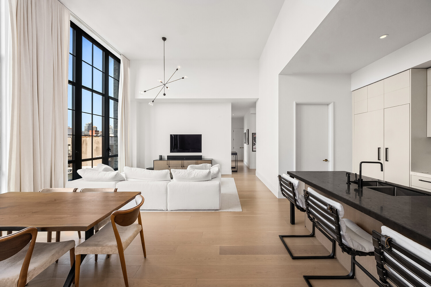 438 East 12th Street, Unit PHF Manhattan, NY 10009 - Photo 4 of 20 a living room with furniture a flat screen tv and a table