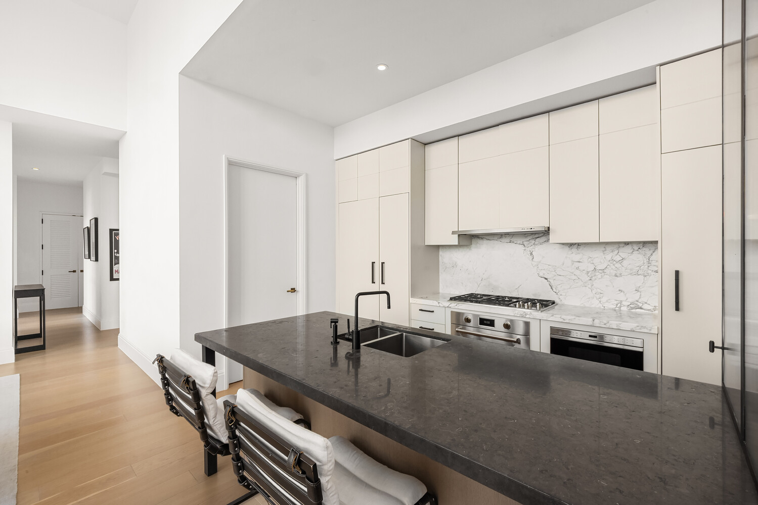 438 East 12th Street, Unit PHF Manhattan, NY 10009 - Photo 5 of 20 a kitchen with stainless steel appliances granite countertop a stove a sink and a refrigerator