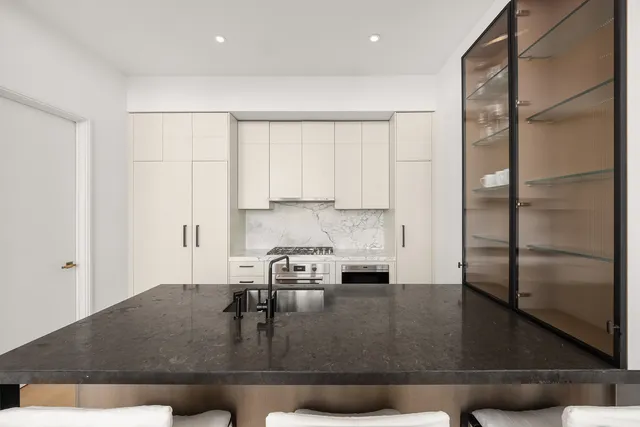 a kitchen with stainless steel appliances granite countertop a stove a sink and a refrigerator