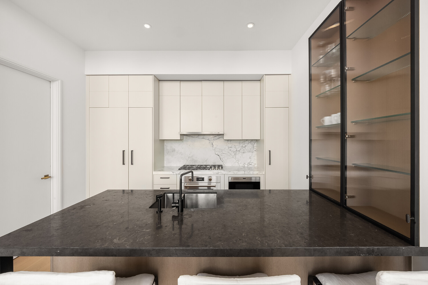 438 East 12th Street, Unit PHF Manhattan, NY 10009 - Photo 6 of 20 a kitchen with kitchen island a counter top and a refrigerator