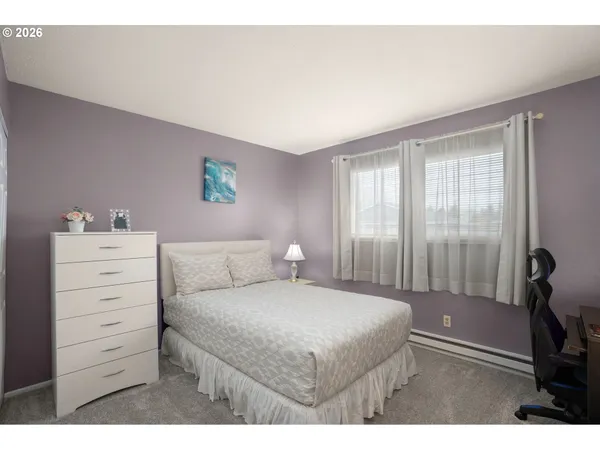a bedroom with a bed and a dresser