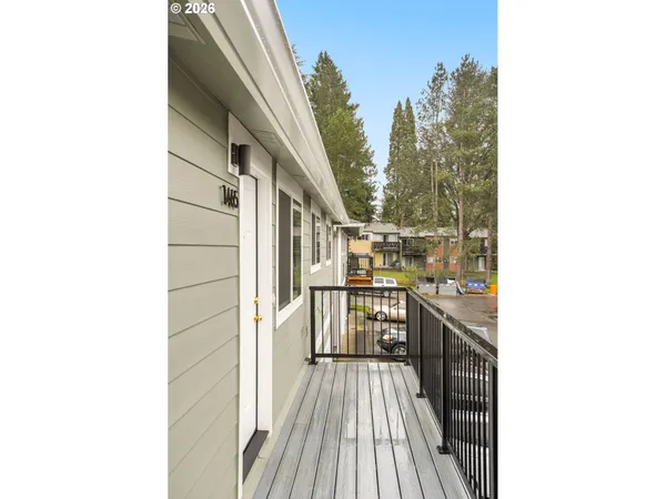 a view of a balcony with wooden floor