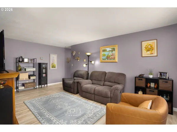 a living room with furniture and a dining table