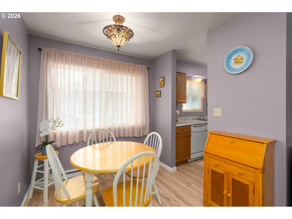 a view of a dining room with furniture and a window