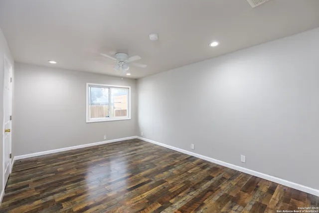 wooden floor in an empty room with a window